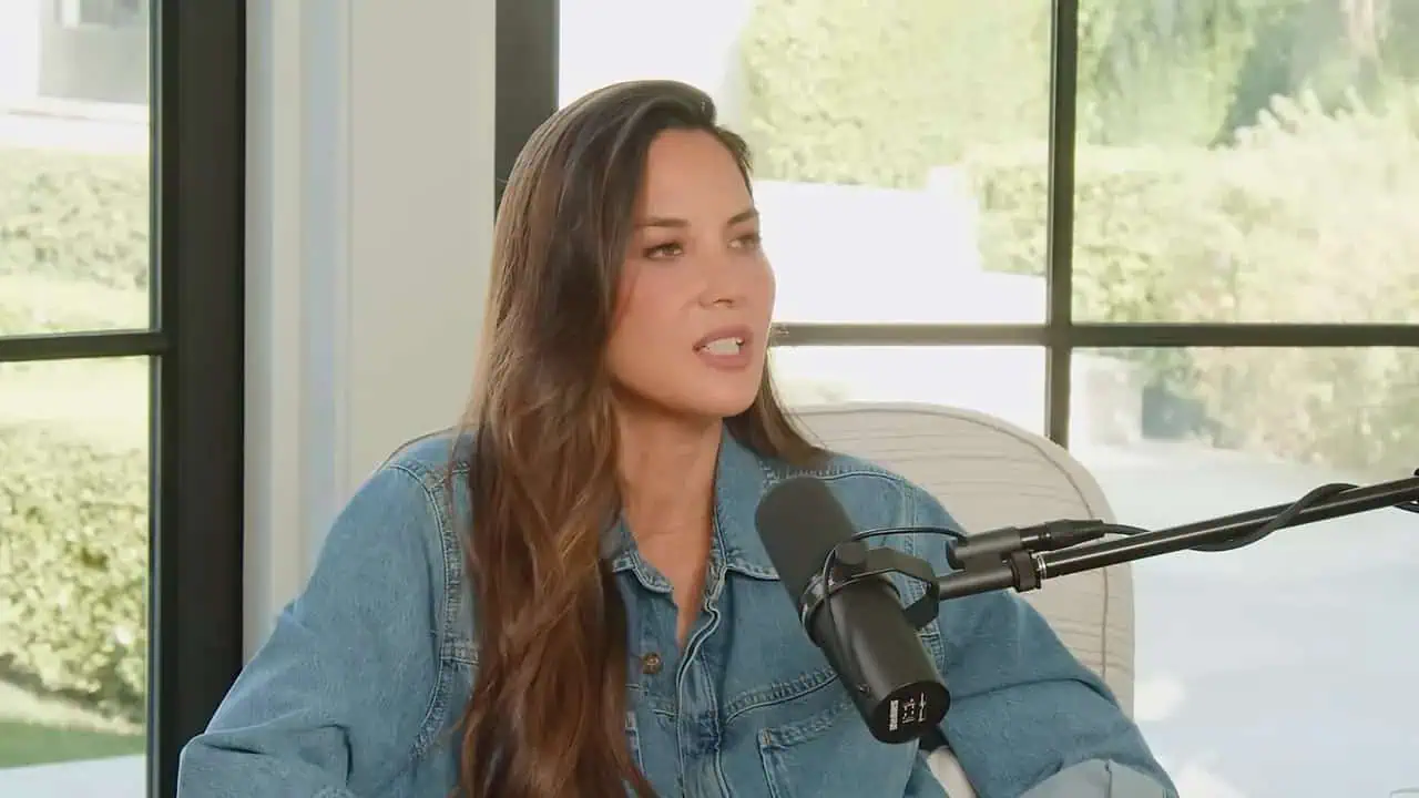 Thais Aliabadi MD speaking into a microphone in a professional setting.